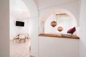 a living room with a table and a mirror at Giojas125- Monolocale per 2 persone in Orosei