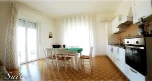 a kitchen with a table and chairs in a room at Casa Tramonto sull' Isola in Marzamemi