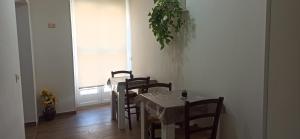 a dining room with a table and chairs and a window at B&B Nuova Salento in Grottaglie +3 photos