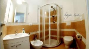 a bathroom with a shower and a toilet and a sink at Casa Tramonto sull' Isola in Marzamemi