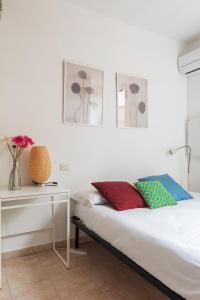 una camera con letto e tavolo con fiori di Monolocale Sarpi a Milano