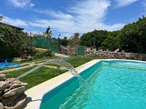 una piscina con una fuente de agua en Casa rural con piscina en Conil de la Frontera - Casa Oeste, en Cádiz
