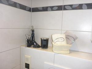 a shelf above the toilet in a bathroom at Ferienhaus am See mit Ruderboot in Mustin +50 photos