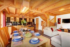 a dining room and kitchen with a table in a room at Chalet des Enfants La Clusaz - OVO Network in La Clusaz