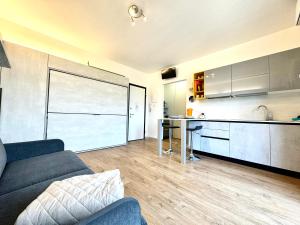 sala de estar con sofá y cocina en Appartamento Perla, en Peschiera del Garda