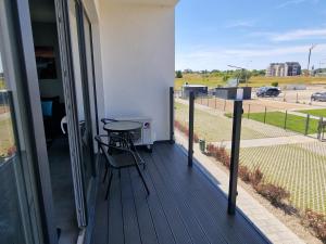 a balcony with a table and a view of a street at Apartamenty u Aleksandry in Ustronie Morskie