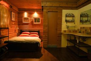 1 dormitorio con cama con almohadas rojas y lavamanos en kfar Navon en Shoval 2