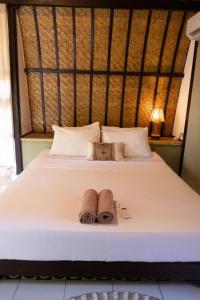 ein Schlafzimmer mit einem Bett mit zwei Handtüchern darauf in der Unterkunft Jungalow in Gili Trawangan