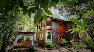 a house in the woods with a tree at MayamYay Privacy Homestay @Mea Nea Chiang Dao in Chiang Dao