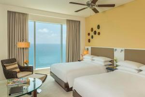 a hotel room with two beds and a window at Hyatt Regency Cartagena in Cartagena de Indias