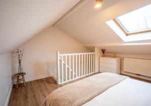 a attic bedroom with a bed and a skylight at Maison cosy et chaleureuse in Marly