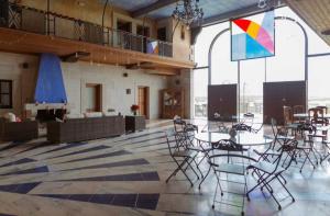 a large room with tables and chairs in a building at Hotel Rural Centro de las Arribes in Aldeadávila de la Ribera