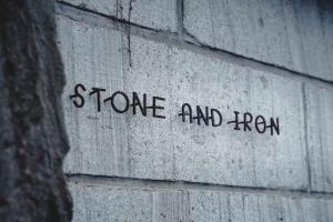 a brick wall with the words stone and iron on it at 石と鉄-House of STONE and IRON in Otaru