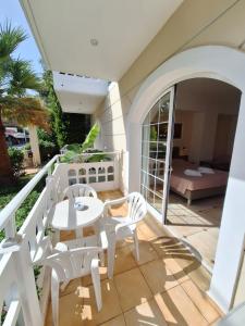 a patio with a table and chairs on a balcony at Perla Beach in Agia Marina Nea Kydonias