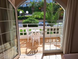 a view of a balcony with a table and chairs at Perla Beach in Agia Marina Nea Kydonias