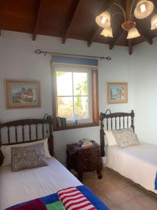 a bedroom with two beds and a window at Apartamento MAR Y TEIDE in Sauzal