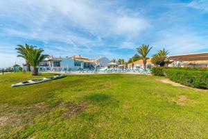 a large yard with a pool and a resort at Sunny Golden 1BDR Apartment w Beach & Pool Access Included in Cabanas de Tavira