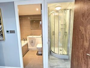 a bathroom with a shower and a toilet at Lovely 3 bedroom Apartment By Sensational Stay Short Lets & Service Accommodation with 6 beds in Edinburgh