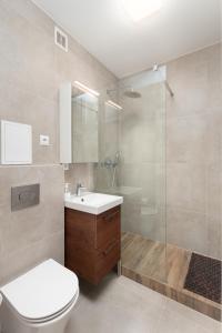 a bathroom with a toilet and a sink and a shower at Oczapowskiego 2 by Homeprime in Warsaw