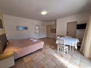 a bedroom with a bed and a table in it at Perla Beach in Agia Marina Nea Kydonias