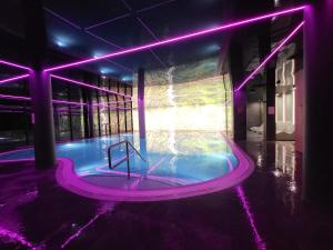 a hot tub in a building with purple lights at Villa6 in Pobierowo