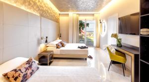 a hotel room with a bed and a desk and a bedroom at Hotel Mondial in Rimini