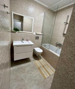 a bathroom with a sink and a toilet and a shower at Апартаменти Парус біля Вікторії Гарденс, Південого in Lviv