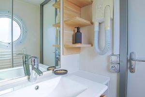 a bathroom with a sink and a mirror at New - Mobil home tout équipé in Saint-Jean-de-Monts