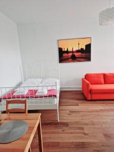 a living room with a bed and a couch at City Studio Apartment for 4, near Sonnenallee in Berlin