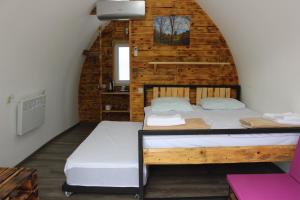 a bedroom with two beds in a log cabin at Glamping Eco Valley in Shahumyan