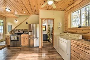 a large kitchen with wooden floors and a refrigerator at Tower Lake Vacation Home & Cabin in Birchwood