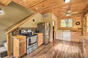 a kitchen with wooden cabinets and a stove at Tower Lake Vacation Home & Cabin in Birchwood