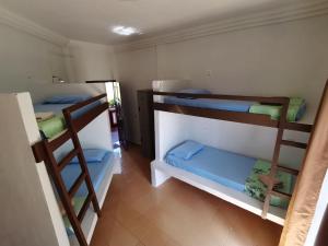 a room with three bunk beds in a room at Matahari Long Beach in Perhentian Islands