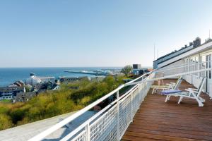 a balcony of a house with a view of the ocean at Hotel Felsen-Eck in Helgoland