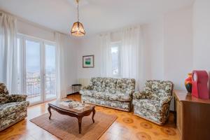 un soggiorno con 2 sedie e un tavolino da caffè di Zio Enry Terrace Apartment Orta Lake - Happy Rentals ad Armeno