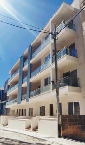 an apartment building with blue pillars on the side of it at Central Malta Apartment in Birkirkara