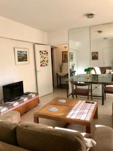 a living room with a couch and a table at Departamento amoblado en Asunción - Paraguay in Asunción