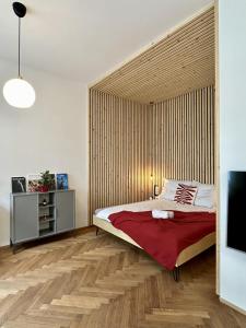 a bedroom with a large bed with a wooden wall at Ateliér U ŘEKY in Ostrava