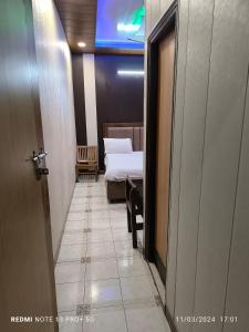 a hallway with a room with two beds and a door at Hotel Diamond palace 45C in Chandīgarh