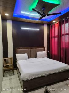 a bedroom with a bed with a blue ceiling at Hotel Diamond palace 45C in Chandīgarh
