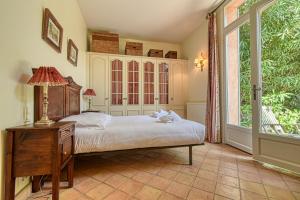a bedroom with a bed and a large window at Beautiful Air-Con House 5min from the Beaches in Cannes