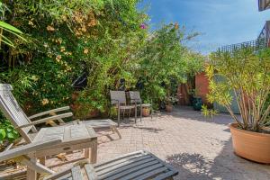 a patio with chairs and trees and plants at Beautiful Air-Con House 5min from the Beaches in Cannes