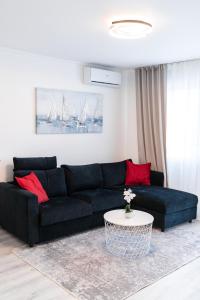 a living room with a black couch and a table at Luxury Apartment in Peaceful Neighborhood Split in Solin