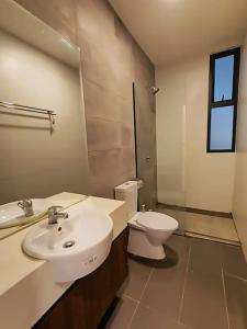 a bathroom with a sink and a toilet at Mupify Homestay Gala City Gala Residences A4 in Kuching