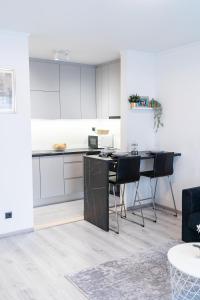 a kitchen with white cabinets and a table and chairs at Luxury Apartment in Peaceful Neighborhood Split in Solin