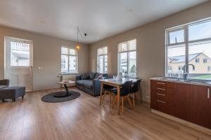 a living room with a couch and a table at Day Dream Strandgata 11 in Akureyri