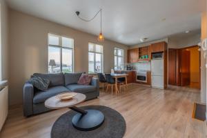 a living room with a couch and a table at Day Dream Strandgata 11 in Akureyri