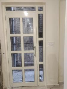 a pair of doors with windows in a room at Pleasant Stay B&B in Amritsar