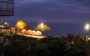 a group of domes on a road at night at A Casa D'Irene in Perea