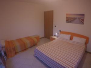 Postel nebo postele na pokoji v ubytování Residence Roberta con piscina - Agenzia Cocal + 42 fotografií